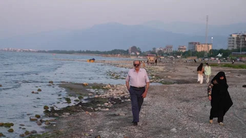 Old couple  walking on the beach Stock Footage 313822667
