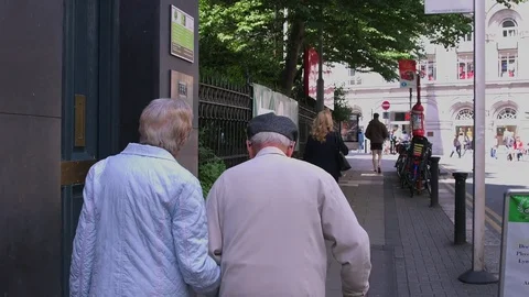 Old Couple Walking In City Stock Footage 82380076