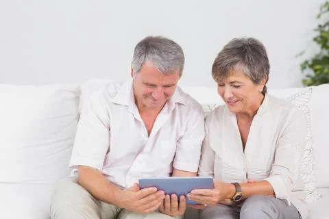 Old couple watching tablet pc Foto stock