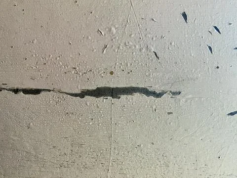 Old Cracked Concrete Wall Texture with Peeling Paint and Deep Horizontal Fissure Stock Photos