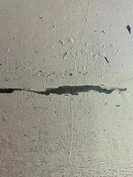 Old Cracked Concrete Wall Texture with Peeling Paint and Deep Horizontal Fissure Stock Photos