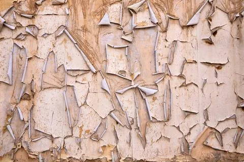 Old, cracked paint texture on the wall of a house. Stock Photos