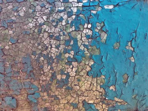 The old cracked paint on a wall surface. Peeling paint on iron background Stock Photos