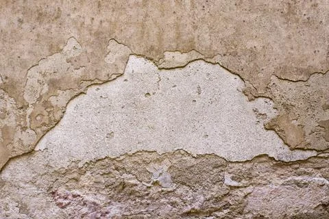 Old cracked rough wall with plaster crumbled Stock Photos