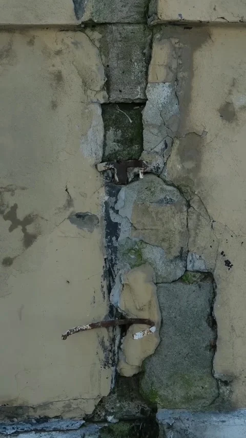 Old Cracked Stone Wall with Peeling Plaster Weathered Surface and Visible Stock Footage 346254383