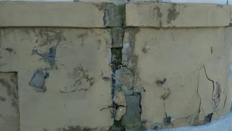 Old Cracked Stone Wall with Peeling Plaster Weathered Surface and Visible Stock Footage 346259556