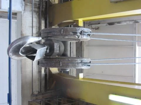 Old crane hook on indoor industrial crane Stock Photos