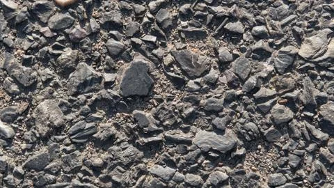 Old crashed road. Black pebbles background. Natural stone. Stock Photos