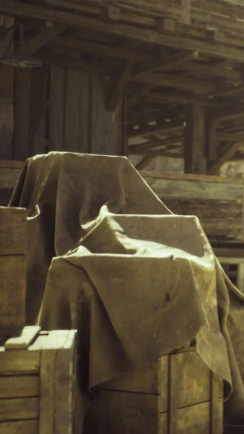 Old crates covered with dusty cloth in a rustic barn setting Stock Footage 340077457
