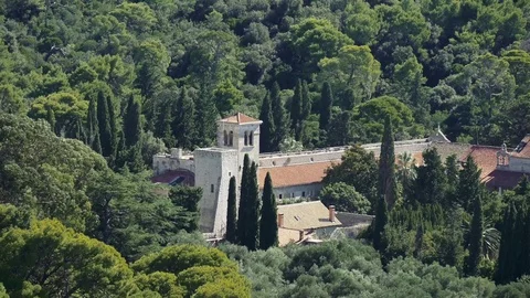Old Croatian monastery surrounded by trees and forest on Lokrum island Stock Footage 71177426