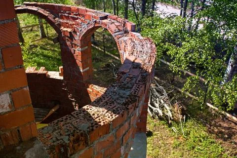 The old crumbling brick wall. Bricks and stones in the old wall. The old brick Stock Photos