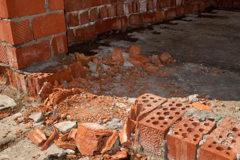 The old crumbling brick wall. Bricks and stones in the old wall. The old brick Stock Photos