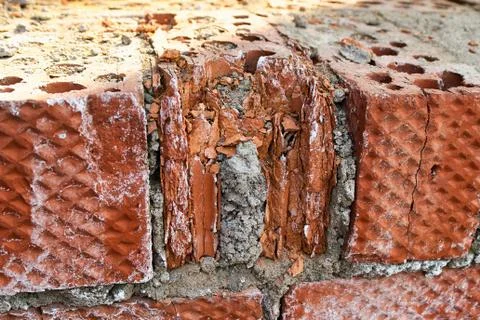 The old crumbling brick wall. Bricks and stones in the old wall. The old brick Foto stock
