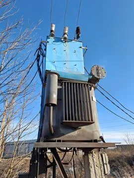 Old current transformer and high voltage electric power lines Stock Photos