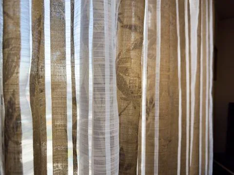 Old curtains against the background of a window in an apartment with an old Stock Photos