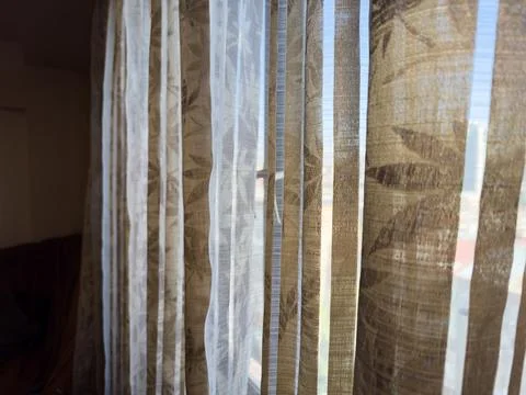 Old curtains against the background of a window in an apartment with an old Stock Photos
