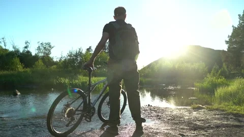 Old cyclist watches the sunset Stock Footage 133489686