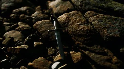 Old dagger on the rock at sunset Illustrazione stock