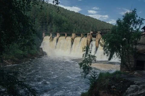 Old dam on a mountain river Stock Photos