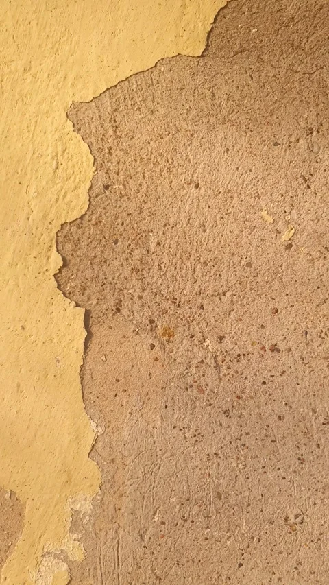 An old, damaged crumbling plaster a damaged surface damaged plaster vertical 库存影片 347606598