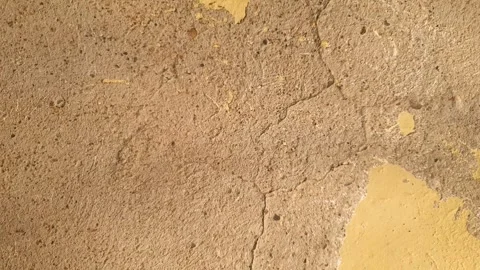 Old, damaged crumbling plaster surface damaged plaster flaking pieces of cement 動画素材 347606669