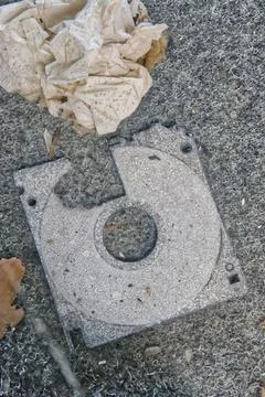 Old Damaged Floppy Disk on Textured Surface Foto stock