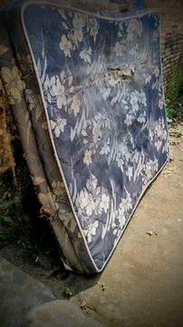 Old Damaged Mattress with Floral Pattern Discarded Outdoors Stock Photos