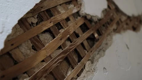 Old damaged plaster wall with exposed wooden lath vintage construction texture Stock-Footage 318922479