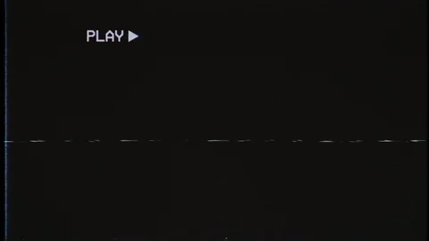 An old damaged VHS tape playing, over noise from an analog TV, with a PLAY text. Stock Footage 113725448
