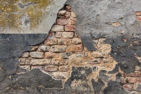 Old damaged wall with bricks and stucco Stock Photos
