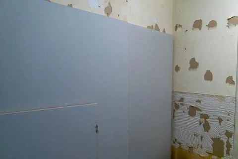 Old damaged wall inside a house in desperate need of fixing and renovation th Stock Photos