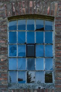 Old damaged window with partially broken glass Stock Photos