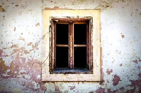 Old damaged window on textured wall Foto stock