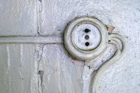 Old damged socket on the wall Stock Photos