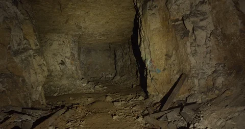 Old dark mine with stone walls and a ceiling. Real quarry made by hands. Stock Footage 127025906