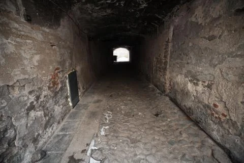 Old dark stone gateway perspective with glowing end. Tallinn, Estonia Stock Photos