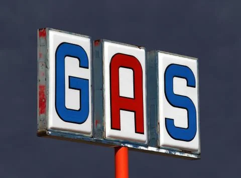 Old decayed gas sign with thunderstorm sky Stock Photos