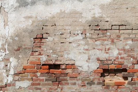 Old decaying concrete red brick exterior wall exposed Stock Photos
