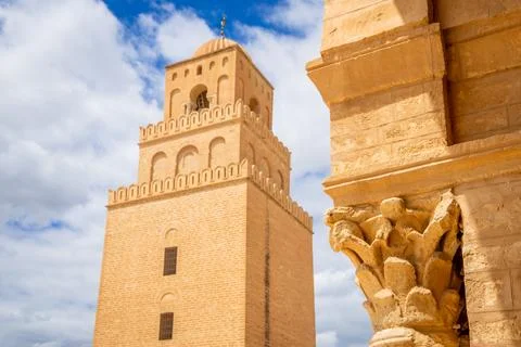 Old decorated column and view to minaret tower of the Great Mosque of Uqba with Stock Photos