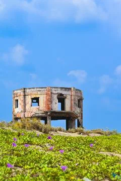An old decrepit white building faces the sea near the Perupalem beach. India. Stock Photos