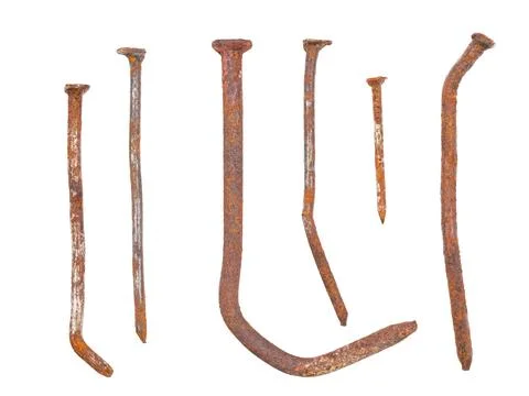 Old deformed and oxidized rusty nails close-up, isolated on white Foto stock