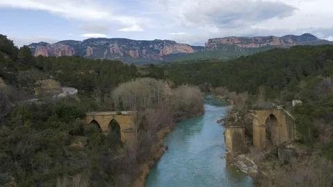 Old delapidated bridge looking toward spectacular mountains Video stock 102513420
