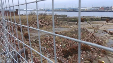 Old deserted ship yard through wire fence Stock Footage 1090485