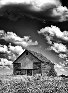 Old desolate barn with storm clouds overhead Stock Photos