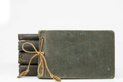 Old destroyed book on a white table. Old-style cover. Stock Photos