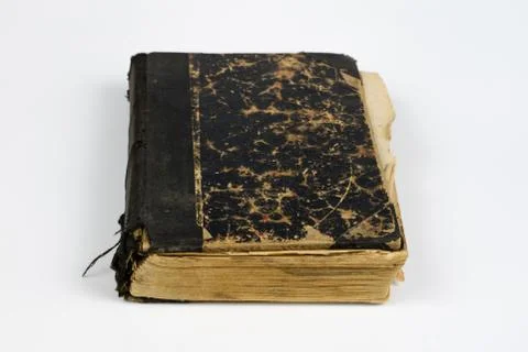 Old destroyed book on a white table. Old-style cover. Stock Photos