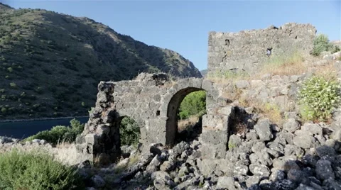 Old destroyed castle with a mountain in the back Stock Footage 60677026