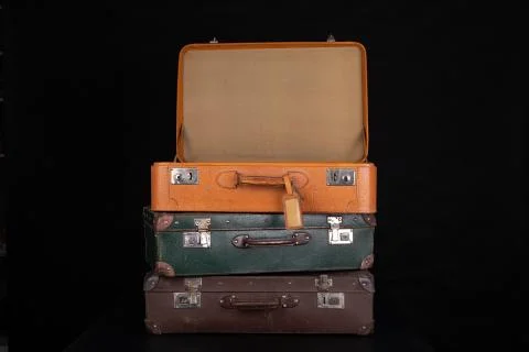 Old destroyed suitcases. Trunks used during long journeys. Stock Photos
