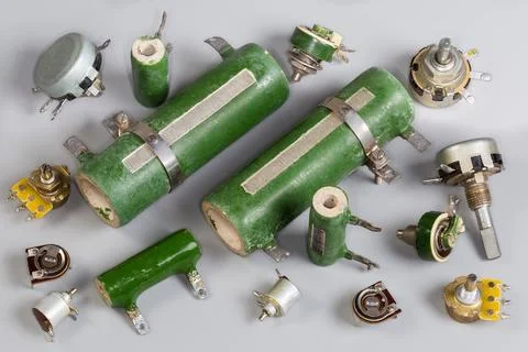 Old different fixed, variable and adjustable resistors on a gray surface 스톡 사진