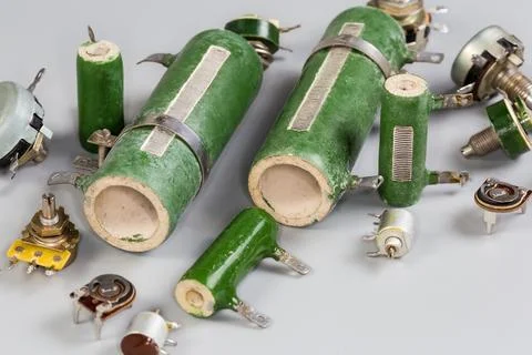 Old different fixed, variable and adjustable resistors on a gray surface Fotos de archivo